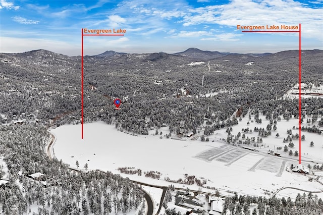 snowy aerial view with a mountain view