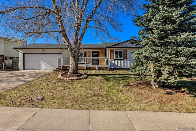 ranch-style house with covered porch, a front yard, and a garage