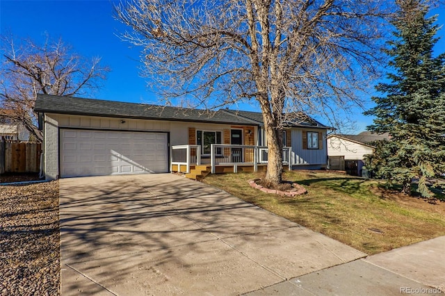 single story home featuring covered porch, a garage, and a front yard