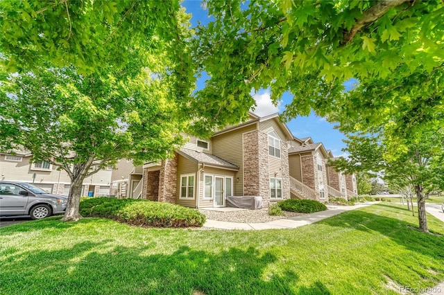 3261 S Waco Ct Unit C, Aurora, CO 80013 - view of front of property featuring stone siding and a front yard