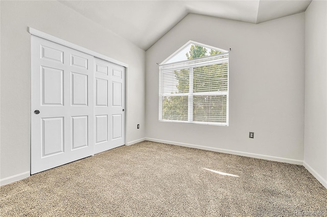 3261 S Waco Ct Unit C, Aurora, CO 80013 - unfurnished bedroom featuring carpet flooring, vaulted ceiling, baseboards, and a closet