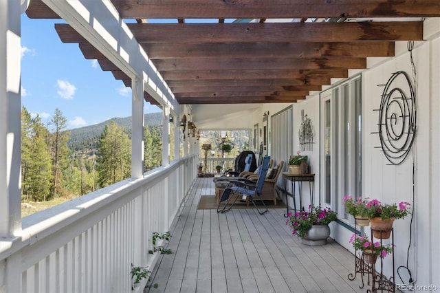 wooden terrace with a mountain view and a pergola