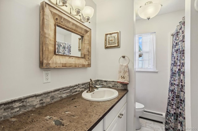 bathroom featuring baseboard heating, vanity, and toilet