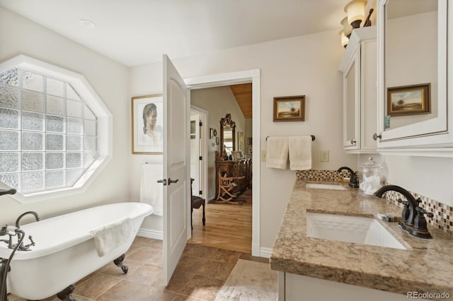 bathroom with vanity, a bathtub, and hardwood / wood-style flooring