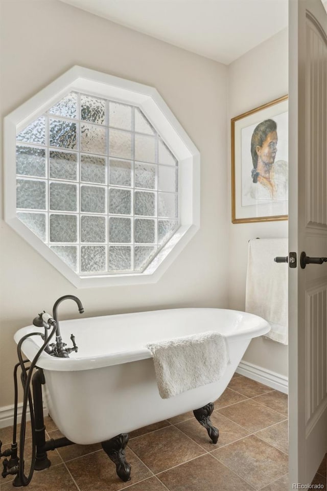 bathroom featuring tile patterned floors and a washtub