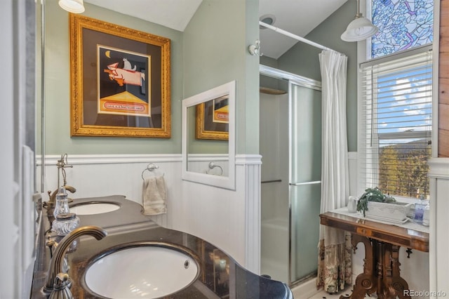 bathroom featuring vanity, lofted ceiling, and curtained shower