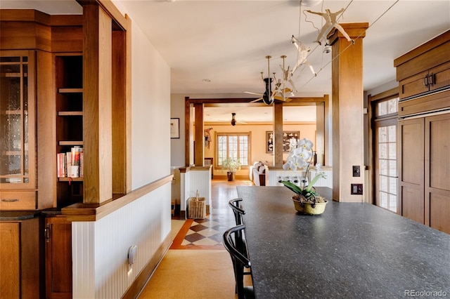 dining room with built in features and ceiling fan