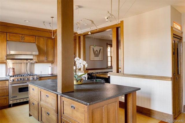 kitchen with tasteful backsplash and designer stove