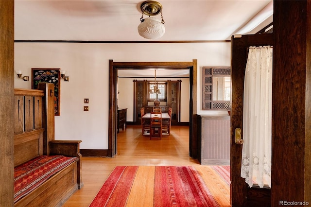 corridor featuring hardwood / wood-style flooring and crown molding