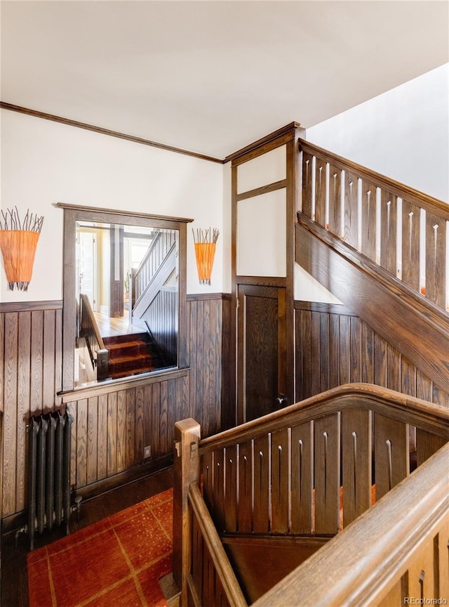 stairs with wood walls and radiator heating unit