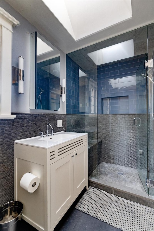 bathroom with an enclosed shower, tile walls, tasteful backsplash, and vanity