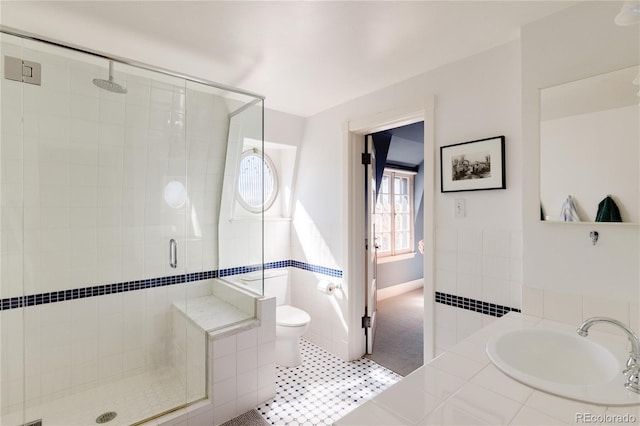 bathroom with tile flooring, toilet, radiator, and a shower with door