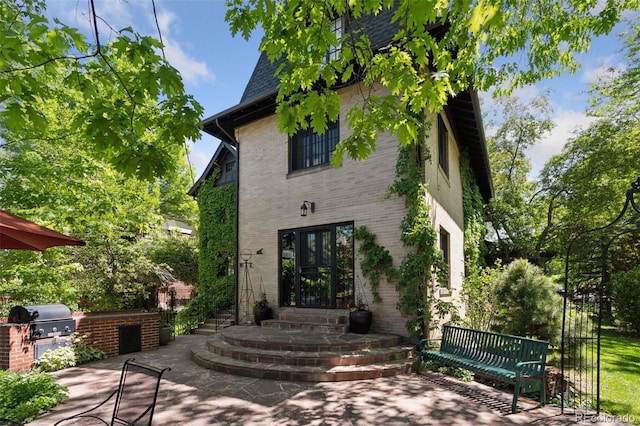 rear view of property featuring a patio area