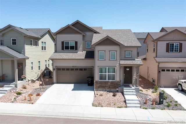 view of front of property with a garage and central AC unit