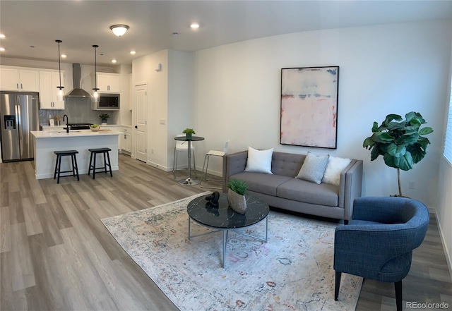 348 N Geneva St, Aurora, CO 80010 - living room with light wood-type flooring, recessed lighting, and baseboards