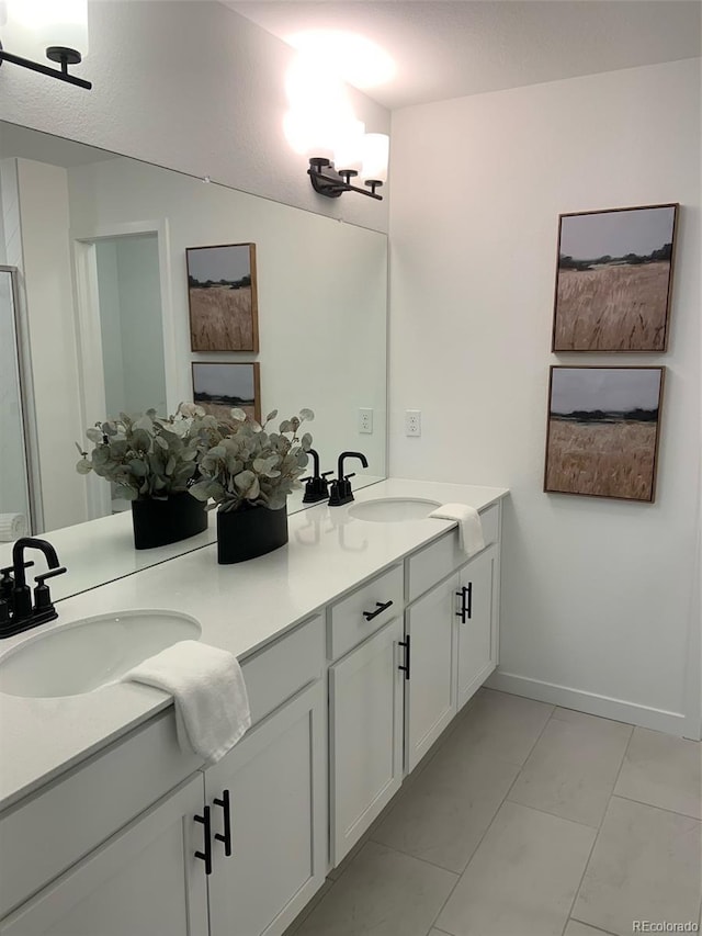 348 N Geneva St, Aurora, CO 80010 - bathroom featuring double vanity and tile patterned floors