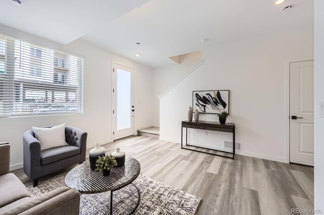 348 N Geneva St, Aurora, CO 80010 - living room with light wood-type flooring, recessed lighting, and baseboards