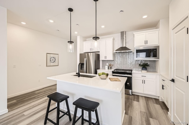 348 N Geneva St, Aurora, CO 80010 - kitchen featuring stove, wall chimney exhaust hood, built in microwave, stainless steel refrigerator with ice dispenser, and a sink