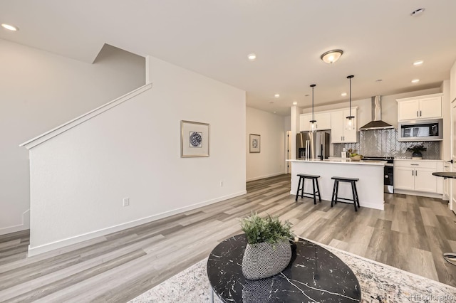 348 N Geneva St, Aurora, CO 80010 - living area with light wood-style flooring, recessed lighting, and baseboards