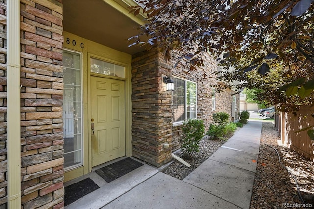 280 Granby Way Unit C, Aurora, CO 80011 - property entrance featuring stone siding and brick siding
