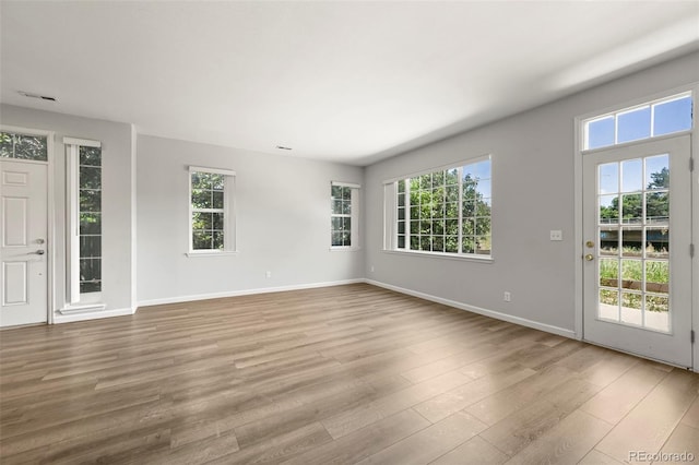 280 Granby Way Unit C, Aurora, CO 80011 - spare room featuring healthy amount of natural light and wood finished floors