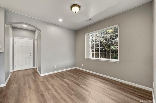 280 Granby Way Unit C, Aurora, CO 80011 - spare room with arched walkways, wood finished floors, and recessed lighting