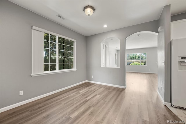 280 Granby Way Unit C, Aurora, CO 80011 - unfurnished room featuring arched walkways, wood finished floors, and recessed lighting