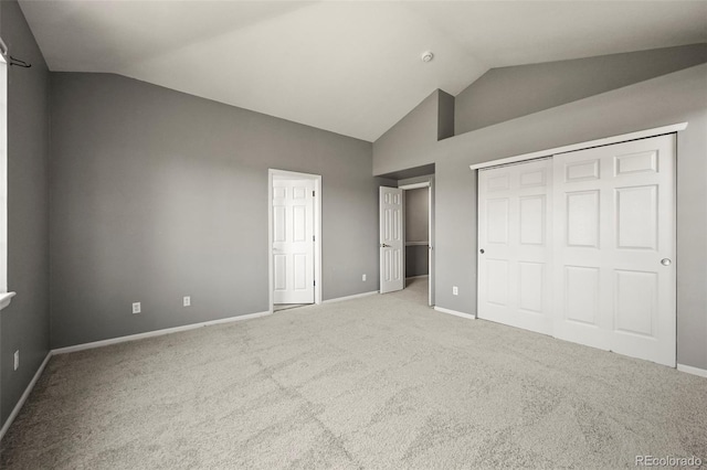 280 Granby Way Unit C, Aurora, CO 80011 - unfurnished bedroom featuring carpet flooring, a closet, and high vaulted ceiling