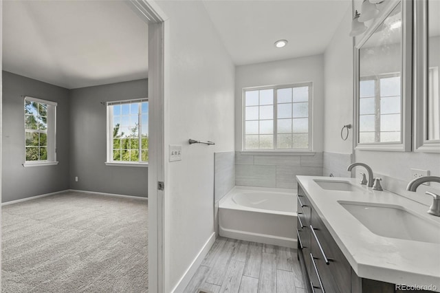 280 Granby Way Unit C, Aurora, CO 80011 - full bath with a garden tub, double vanity, and wood finished floors