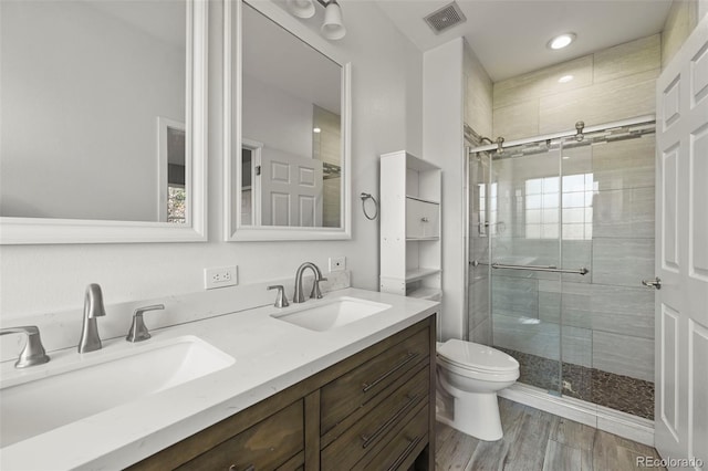 280 Granby Way Unit C, Aurora, CO 80011 - bathroom with a stall shower, double vanity, wood finished floors, and recessed lighting