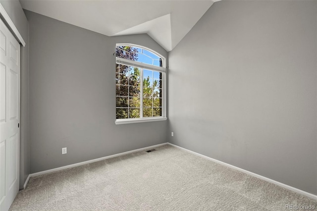 280 Granby Way Unit C, Aurora, CO 80011 - unfurnished bedroom featuring carpet floors, vaulted ceiling, and a closet