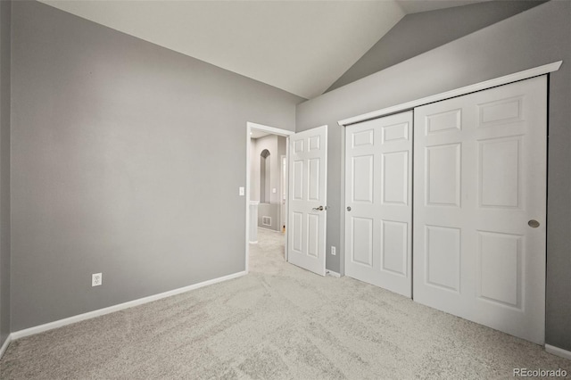 280 Granby Way Unit C, Aurora, CO 80011 - unfurnished bedroom with vaulted ceiling, carpet, and a closet