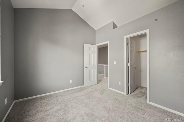 280 Granby Way Unit C, Aurora, CO 80011 - unfurnished bedroom featuring high vaulted ceiling, light colored carpet, and a walk in closet