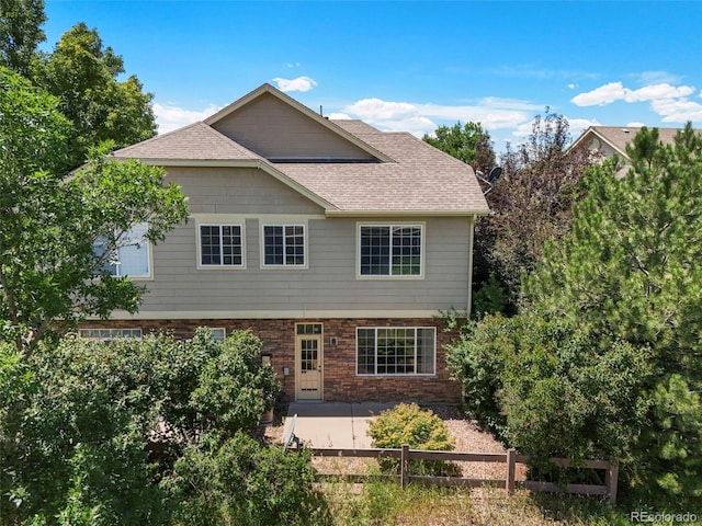 280 Granby Way Unit C, Aurora, CO 80011 - back of house featuring a patio area, roof with shingles, and brick siding