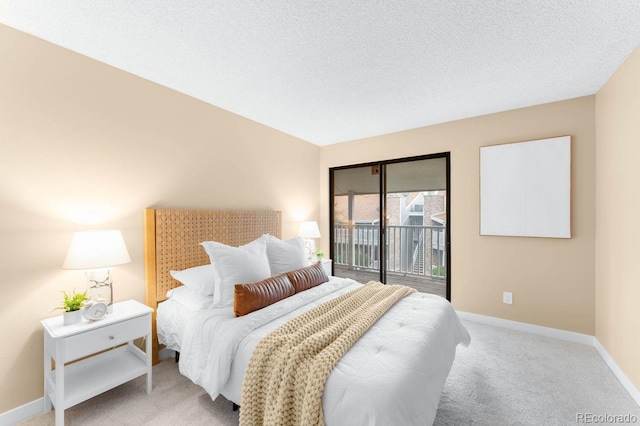 bedroom featuring access to exterior, carpet, baseboards, and a textured ceiling
