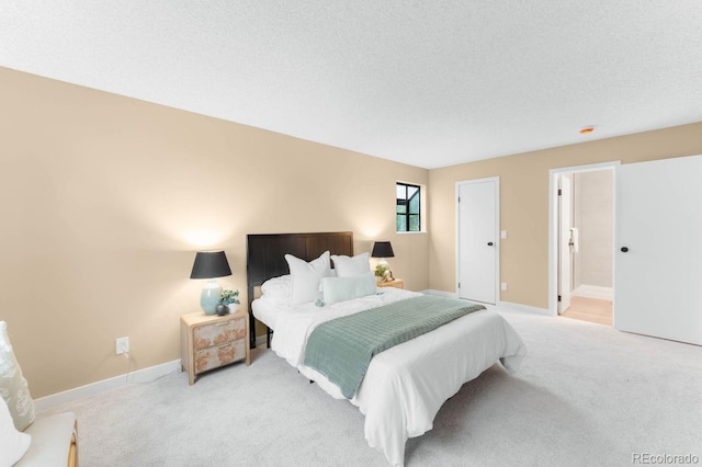 bedroom featuring light colored carpet and baseboards
