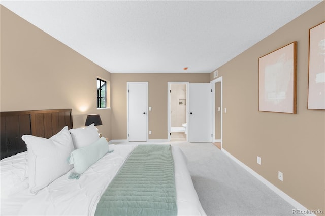 921 S Walden St Unit 205, Aurora, CO 80017 - bedroom with baseboards, light carpet, and connected bathroom
