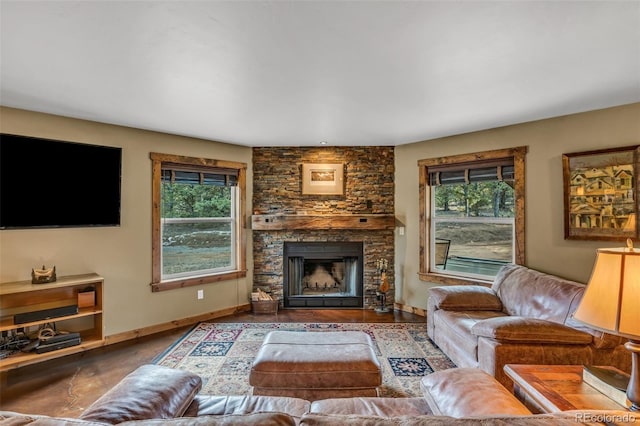 living room featuring a stone fireplace