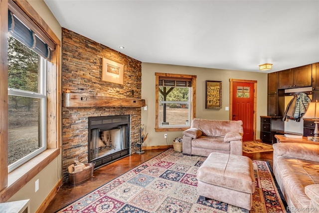 living room featuring a stone fireplace