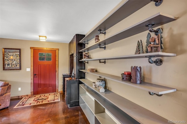 entrance foyer featuring finished concrete flooring and baseboards