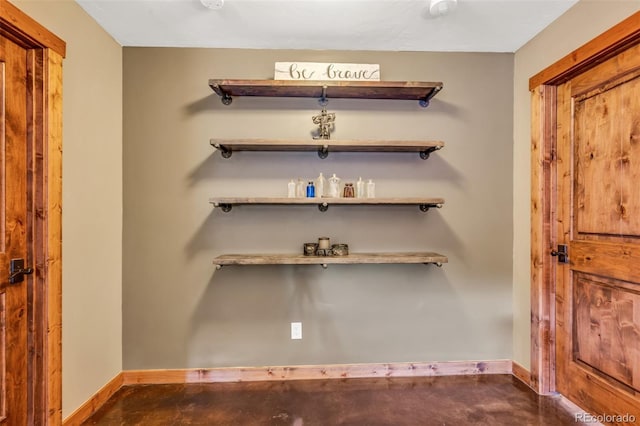 interior space with baseboards and concrete floors