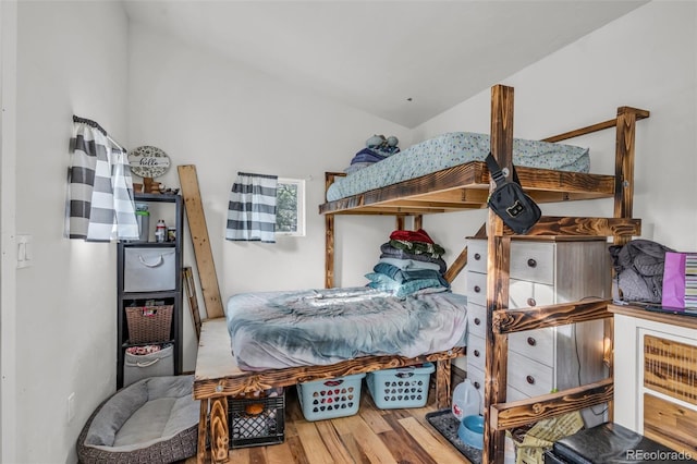 bedroom featuring vaulted ceiling and hardwood / wood-style floors