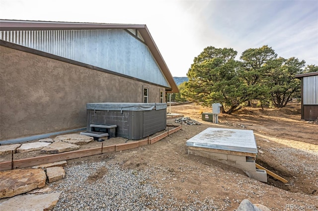 exterior space with a hot tub