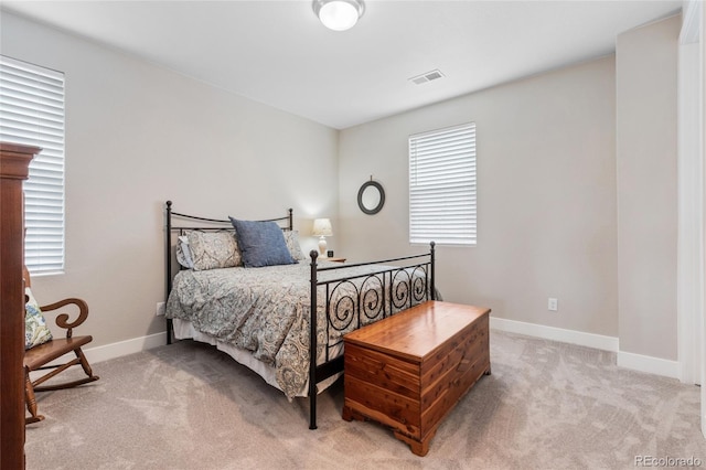 carpeted bedroom with visible vents and baseboards