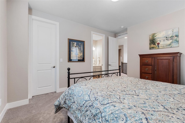 bedroom featuring light carpet, ensuite bath, visible vents, and baseboards