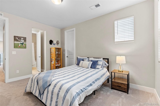 bedroom featuring light colored carpet, visible vents, and baseboards