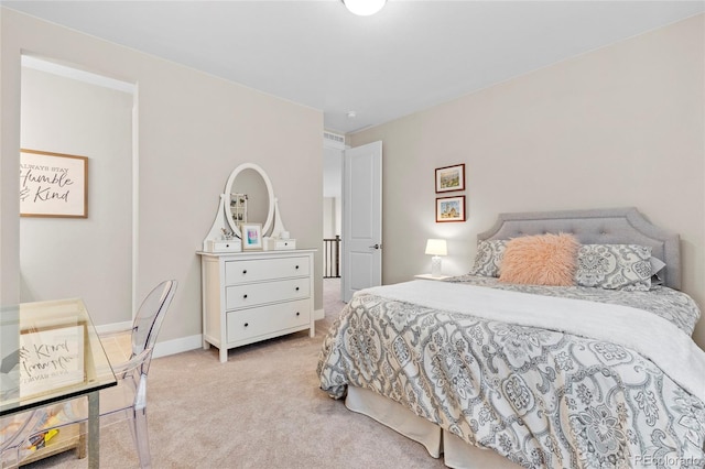 bedroom with light carpet and baseboards