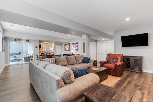 living area featuring baseboards, wood finished floors, and recessed lighting