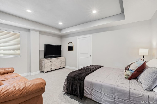 bedroom featuring recessed lighting, a tray ceiling, light colored carpet, and baseboards