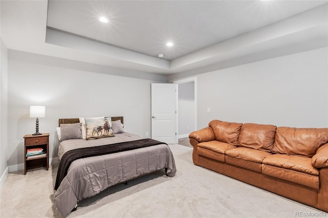 bedroom with recessed lighting, a raised ceiling, light colored carpet, and baseboards